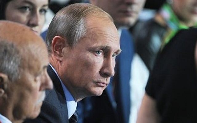 Russian President Vladimir Putin, center, listens to a question during a meeting with his supporters in Moscow, Russia, Monday, Sept.  7, 2015 (Mikhail Klimentyev/RIA-Novosti, Kremlin Pool Photo via AP)