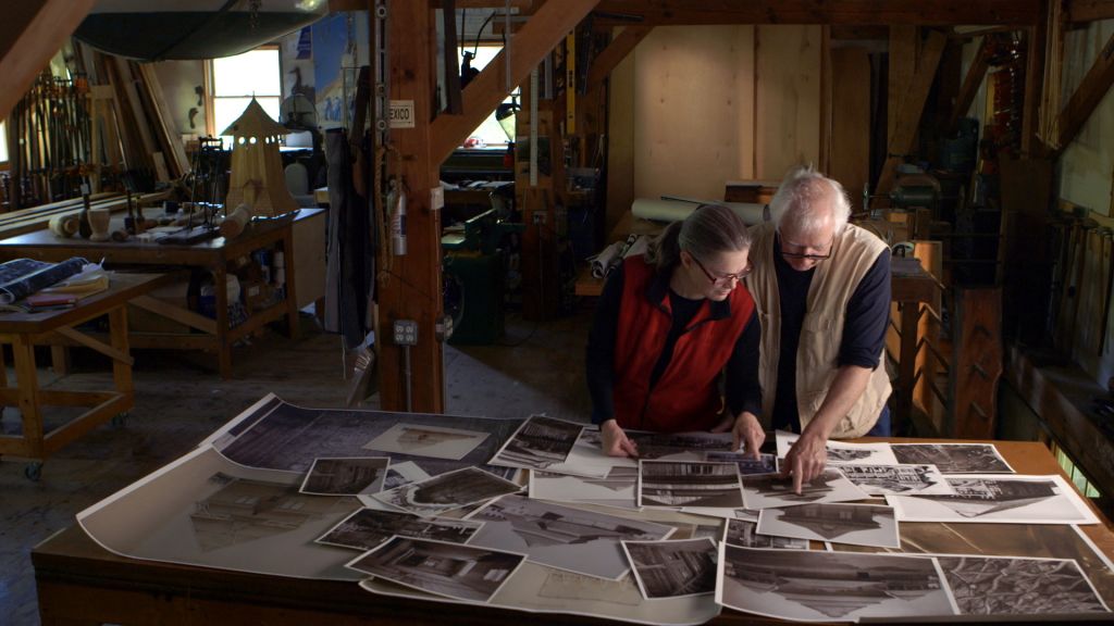 Artists Rick and Laura Brown review details on photographs of the Polish synagogues that no longer exist to aid in the reconstruction of the Gwoździec synagogue. (Trillium Studios production)