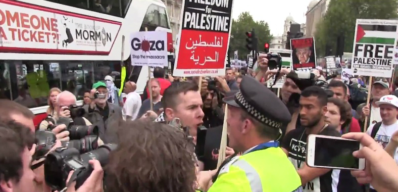 Metropolitan Police face off against pro-Palestinian demonstrators during protests outside Downing Street in London as Prime Minister Benjamin Netanyahu met with British counterpart David Cameron on September 9, 2015. (screen capture: YouTube)