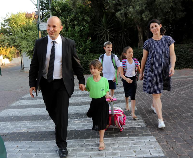 Education Minister Naftali Bennett walks his little girl Avigail to first grade, her first day of school and his first opening of a school year as the education minister, on Tuesday, September 1, 2015. (Sasson Tiram)
