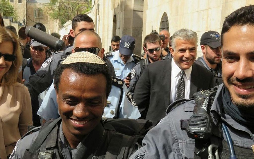Yesh Atid leader Yair Lapid (in suit and tie) during a tour by members of his party to the Old City in Jerusalem. (Courtesy Yesh Atid)