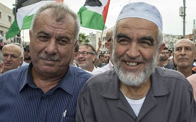 Islamic Movement leader Sheikh Raed Salah (right), and former Arab MK Mohammad Barakeh attend a demonstration in Sakhnin on October 13, 2015. (AFP/Jack Guez)