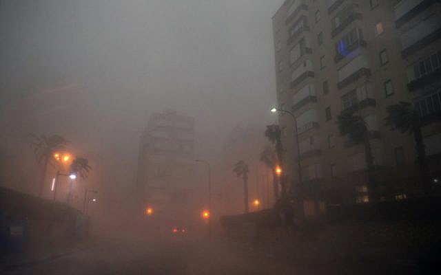 Cars drive through the haze in the Israeli Mediterranean town of Netanya, north of Tel Aviv on October 25, 2015 as a storm hits the area.(AFP/ JACK GUEZ)