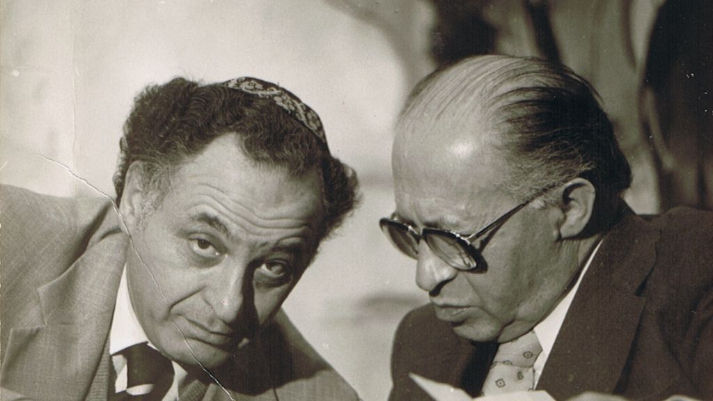 Prime Minister Menachem Begin (right) confers with advisor Yehuda Avner. (Courtesy of Moriah Films)