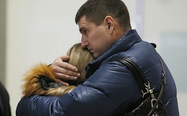 Relatives react after a Russian airliner with 217 passengers and seven crew aboard crashed, as people gather at Russian airline Kogalymavia’s information desk at Pulkovo airport in St. Petersburg, Russia, Saturday, Oct. 31, 2015. (AP Photo/Dmitry Lovetsky)