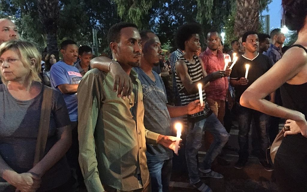 Mourners at a memorial for Haftom Zarhum, an Eritrean mistaken for a terrorist and killed, at Tel Aviv Levinsky Park on October 21, 2015. (Sara Miller/Times of Israel)