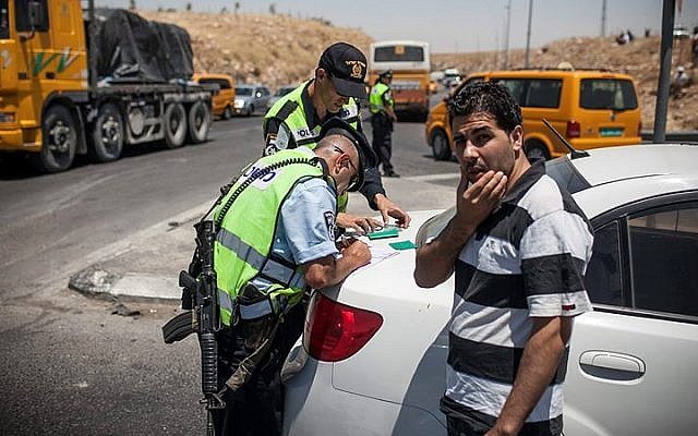 Illustrative: Police examining Palestinians on their way to Ramallah near the Adam Junction. (Noam Moskowitz/Flash90)
