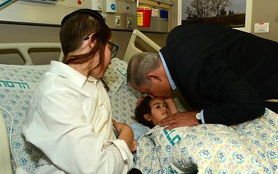 Prime Minister Benjamin Netanyahu visits Adele Banita and her baby son, who were injured in a terror attack in Jerusalem's Old City on October 3, 2015 in which Aharon Banita was killed, at Hadassah Ein Kerem hospital in Jerusalem on October 5, 2015. (Photo by Kobi Gideon/GPO)