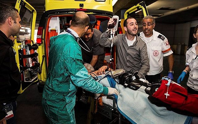 Medics wheel a wounded Israeli into the emergency room of the Shaare Zedek Medical Center on October 26, 2015, after a Palestinian man stabbed him near the West Bank city of Hebron. (Yonatan Sindel/Flash90)