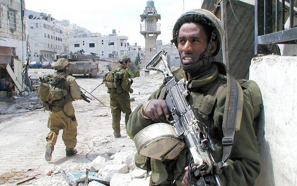 An IDF soldier stands guard in Nablus during Operation Defensive Shield in 2002. (IDF Spokeserson's Unit/Flickr)