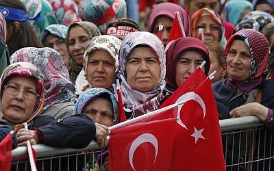 In this May 30, 2015, file photo, supporters of Turkey's president, Recep Tayyip Erdogan, and prime minister and leader of the Justice and Development Party (AKP), Ahmet Davutoglu, some holding Turkish flags, wait for their appearance in Istanbul during a rally to commemorate the anniversary of city's conquest by the Ottoman Turks. (AP Photo/Lefteris Pitarakis file)