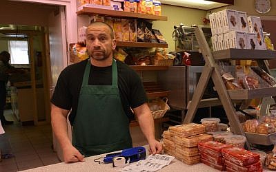 Deli owner Michiel Cornelissen says the opening of a refugee center in a heavily Jewish area of Amsterdam represents an “unwarranted risk.” (Cnaan Liphshiz/JTA)