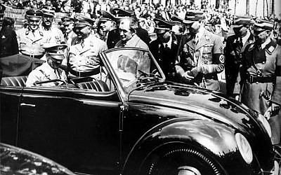 Adolf Hitler climbs into a Beetle at the Volkswagen factory in Wolfsburg in 1938 (Courtesy)
