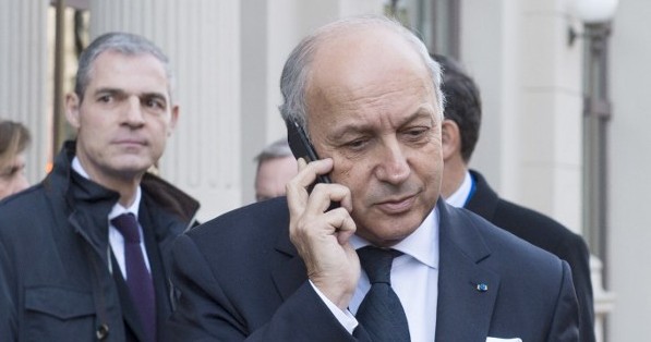 French Foreign Minister Laurent Fabius speaks on the phone as he arrives for a conference on Syria in Vienna on November 14, 2015, a day after 130 people were killed in terror attacks in Paris. (AFP PHOTO/JOE KLAMAR)