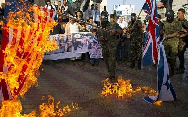 Palestinian militants burn the British, US and Israeli flags during a demonstration to mark the anniversary of the Balfour Declaration in the southern Gaza Strip town of Rafah on November 2, 2015. (AFP PHOTO/SAID KHATIB)