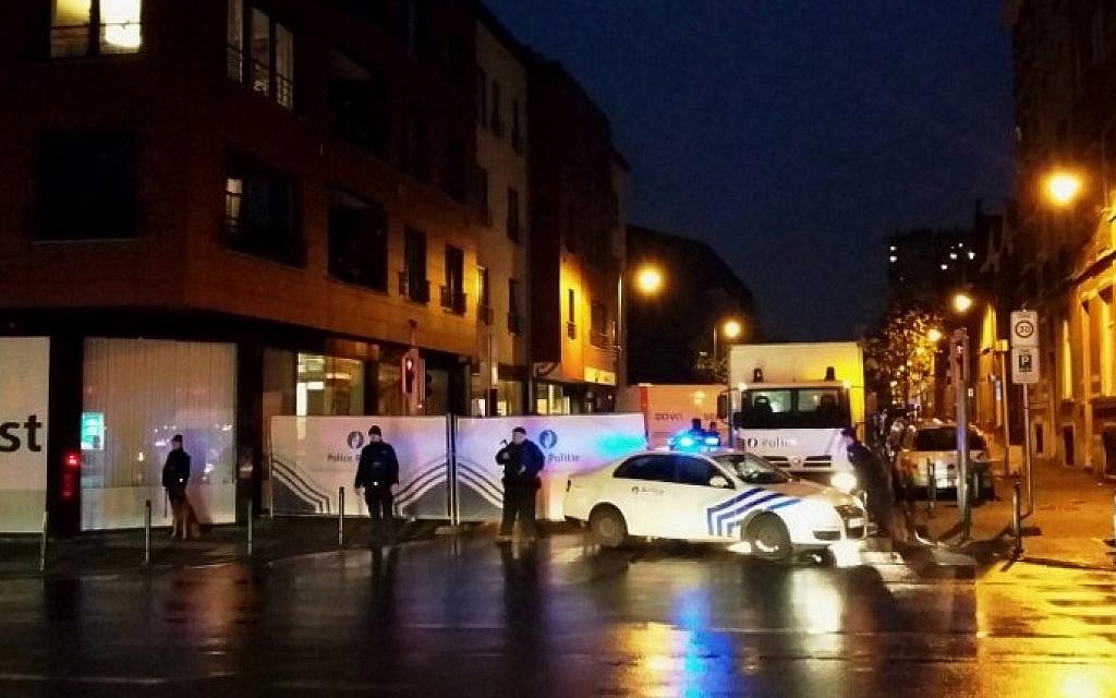 Belgian police blocking a street during a police raid in Brussels' Molenbeek district on November 14, 2015 (Hendrick Devriendt/AFP)