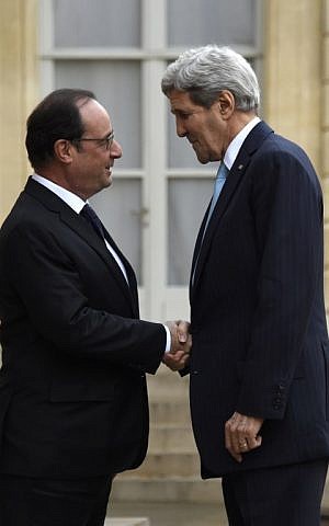 French President Francois Hollande greets US Secretary of State John Kerry upon his arrival for their talks at the Elysee palace in Paris on November 17, 2015. (Photo by AFP Photo / Dominique Faget)