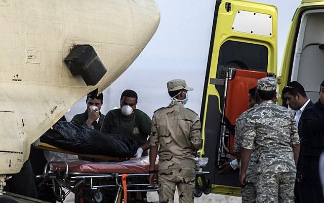 Egyptian paramedics load the corpses of Russian victims of a Russian passenger plane crash in the Sinai Peninsula, into a military plane at Kabret military air base by the Suez Canal on October 31, 2015. (AFP PHOTO / KHALED DESOUKI)