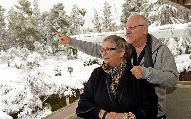 File: President Reuven Rivlin and his wife Nechama look at the snow-covered garden at the President's Residence in Jerusalem after a snowstorm hit the capital in February 2015. (Haim Zach/GPO)