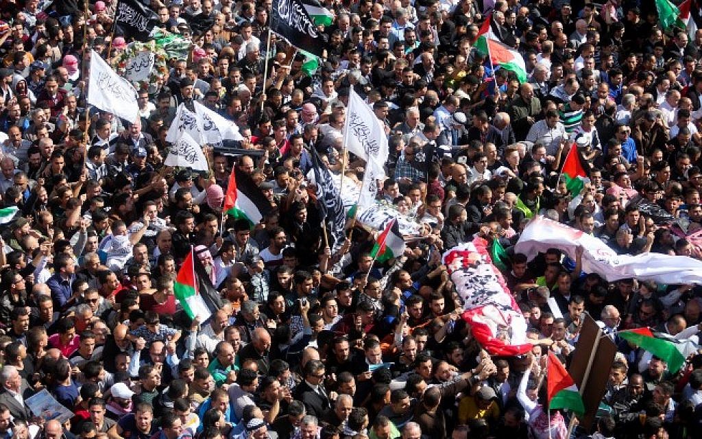 Palestinians carry the corpses of terrorists through the streets of Hebron during a massive funeral march in the West Bank, October 31, 2015. (Flash90)