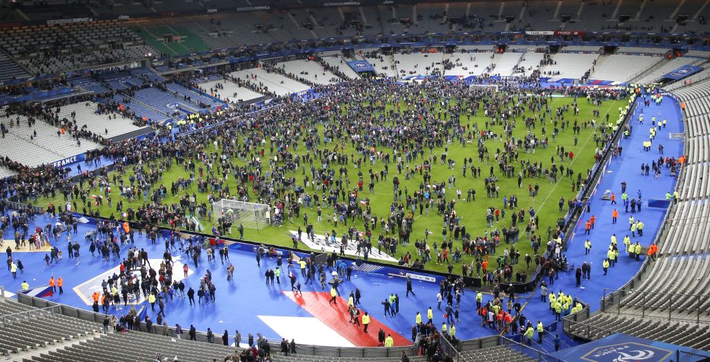 Spectators invade the pitch of the Stade de France stadium after the international friendly soccer France against Germany, Friday, November 13, 2015 in Saint Denis, outside Paris. During the first half of France's soccer match against Germany on Friday, two explosions went off nearby. (Photo by AP Photo/Michel Euler)