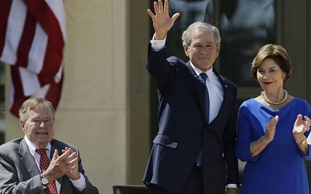 In this April 25, 2013, file photo, Former President George H.W. Bush, left, applauds with Laura Bush after former President George W. Bush's speech during the dedication of the George W. Bush Presidential Center in Dallas. (AP Photo/David J. Phillip, File)
