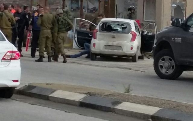 Soldiers at the scene of a car-ramming attack at the Tapuah Junction in the West Bank on Sunday, November 8, 2015. (Raya Bloch)