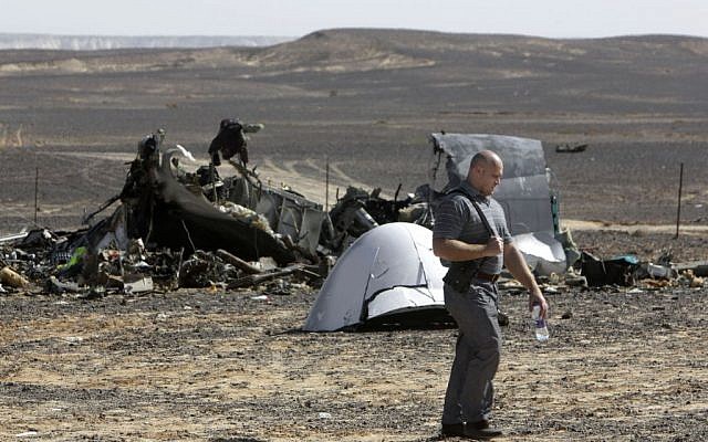 A Russian investigator walks near wreckage November 1, 2015, a day after a passenger jet bound for St. Petersburg, Russia, crashed in Hassana, Egypt. (AP/Amr Nabil, File)