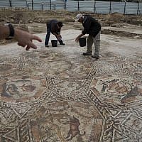 Employees of Israel’s antiquities authority work on a 1,700-year-old Roman-era mosaic floor in Lod, Israel, Monday, Nov. 16, 2015 (AP Photo/Ariel Schalit)