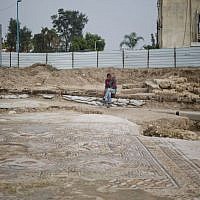 An Arab employee of Israel’s antiquities authority works on a 1,700-year-old Roman-era mosaic floor in Lod, Israel, Monday, Nov. 16, 2015 (AP Photo/Ariel Schalit)