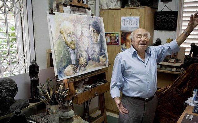In this photo taken Tuesday, November 10, 2015, artist Itzchak Belfer, who grew up in an orphanage headed by Janusz Korczak, displays a painting of his mentor at his house in Tel Aviv, Israel. (AP Photo/Dan Balilty)