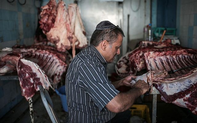 Illustrative image of a man preparing meat at a kosher slaughterhouse (AP Photo/Mosa'ab Elshamy)