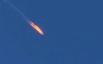 Screen capture from video by Haberturk TV showing a Russian warplane on fire before crashing on a hill as seen from Hatay province, Turkey, November 24, 2015. (Haberturk TV via AP)