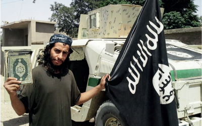 Abdelhamid Abaaoud, the suspected mastermind of the Paris terror attacks on November 13, 2015, waves an Islamic State flag in this undated picture taken from a magazine published by IS. (screenshot)