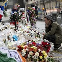 Drummer of the US rock group Eagles of Death metal Julian Dorio pays tribute to the victims of the November 13 Paris terrorist attacks at a makeshift memorial in front of the Bataclan concert hall in Paris on December 8, 2015. (Miguel Medina/AFP)