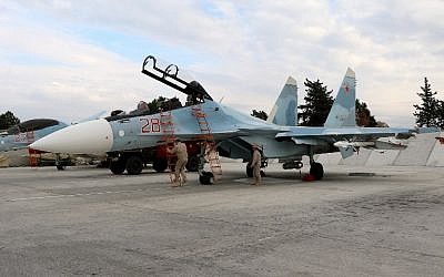 Russian servicemen prepare a Russian Sukhoi Su-30SM fighter jet before a departure for a mission at the Russian Hmeimim military base in Latakia province, in the northwest of Syria, on December 16, 2015.  (AFP/Paul GYPTEAU)