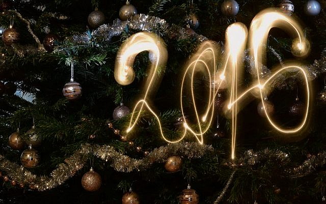 This long-exposure picture taken in Budapest on December 31, 2015 shows the new year 2016 written with a flashlight in front of a Christmas tree. (AFP/Attila Kisbenedek)