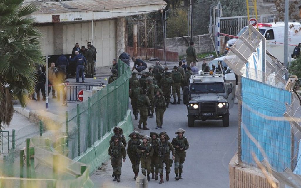 File: Israeli security forces gather at the site where a Palestinian stabbed an Israeli near the Tomb of the Patriarchs in Hebron, on December 7, 2015. (AFP/Hazem Bader)