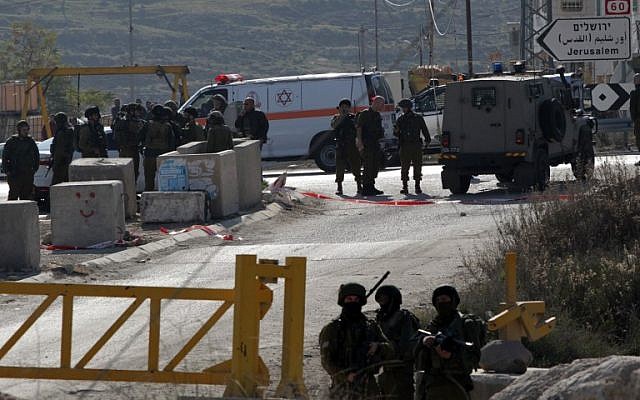 Illustrative: Israeli security forces in Hebron on December 24, 2015. (AFP Photo/Hazem Bader)