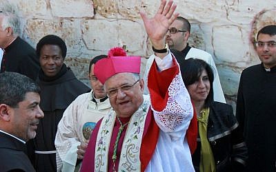 The head of the Roman Catholic Church in the Holy Land, the Latin Patriarch of Jerusalem Fuad Twal (C) greets the crowd outside the Church of the Nativity as Christians gather for Christmas celebrations in the West Bank city of Bethlehem, on December 24, 2015.(AFP PHOTO/ MUSA AL SHAER / AFP / MUSA AL-SHAER)