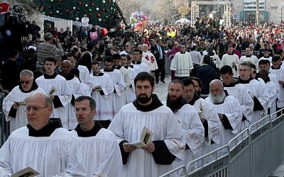 Clergymen march in Manger Square outside the Church of the Nativity as Christians gather for Christmas celebrations in the West Bank city of Bethlehem, on December 24, 2015.(AFP PHOTO/ MUSA AL SHAER / AFP / MUSA AL-SHAER)