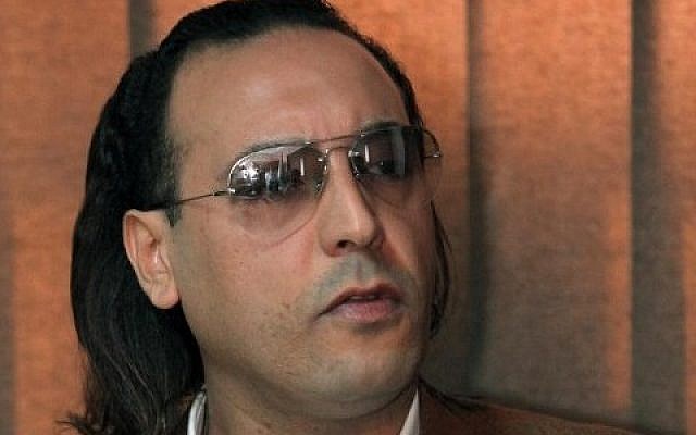 A file picture taken on March 1, 2010 shows Hannibal Gaddafi, a son of the late Libyan dictator Muammar Gaddafi, speaking to a jailed Swiss businessman during a meeting at Al-Jadaida prison on the outskirts of Tripoli. (AFP PHOTO / MAHMUD TURKIA)