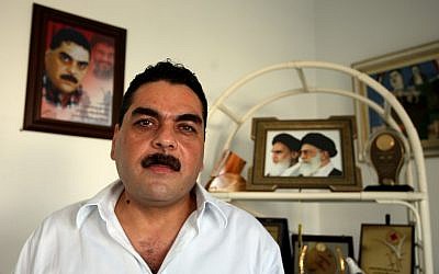 A file picture taken on October 22, 2008, shows Samir Kuntar posing for a picture during an interview on the outskirts of Beirut. In the background is a photograph of the Iranian supreme leader, Ayatollah Ali Khamenei (AFP PHOTO/JOSEPH BARRAK)