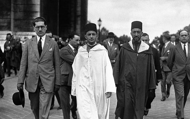 File: Morocco's Mohammed V, wearing white robes, walking with the country's Grand Vizier Si Mohammed El Mokri after he placed a wreath on the Tomb of the Unknown Warrior at the Arc De Triomphe during a visit to Paris, France around July 4, 1930. (AP Photo)