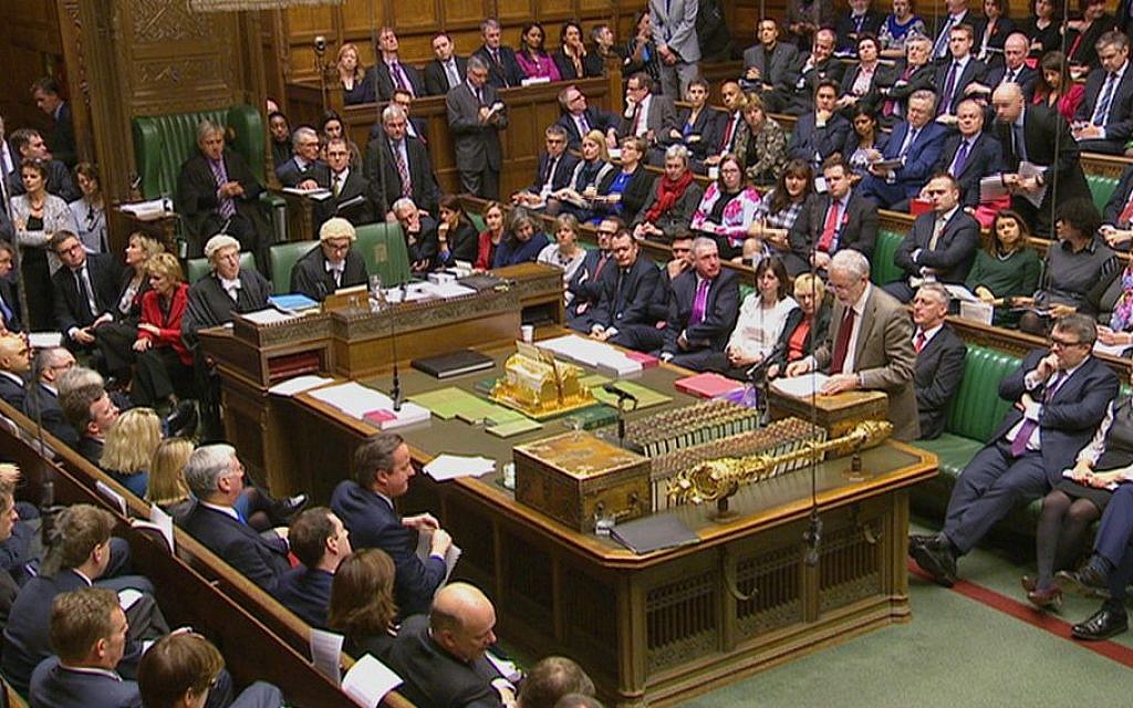 Illustrative: Opposition Labour Party leader, Jeremy Corbyn, stands right, as he makes a speech to lawmakers inside the House of Commons in London as Britain's Prime Minister David Cameron sits at center left, during a debate on launching airstrikes against Islamic State extremists inside Syria, December 2, 2015. (Photo by Parliamentary Recording Unit via AP Video)