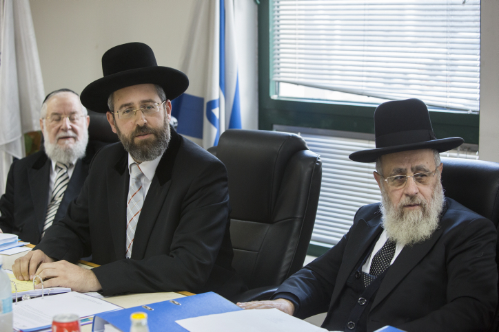Chief Ashkenazi Rabbi David Lau (center) and Sephardi Chief Rabbi Yitzhak Yosef (right) attend a meeting of the Rabbinate Council in Jerusalem in November 2014. (Yonatan Sindel/Flash90)