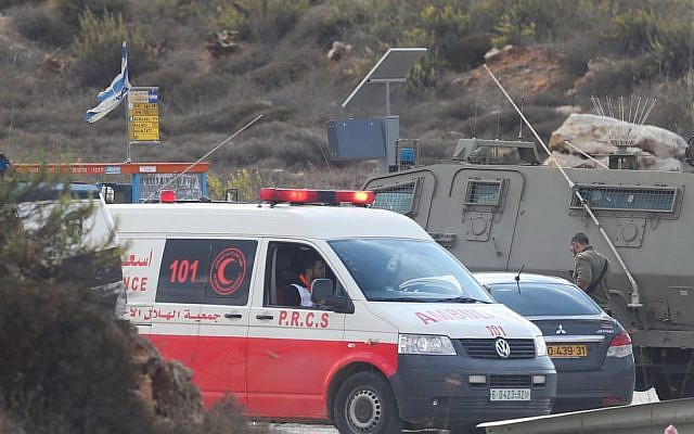 Illustrative: Israeli security forces and a Palestinian Red Crescent ambulance at the Tapuah junction near the West Bank city of Nablus, October 30, 2015. (Flash90)