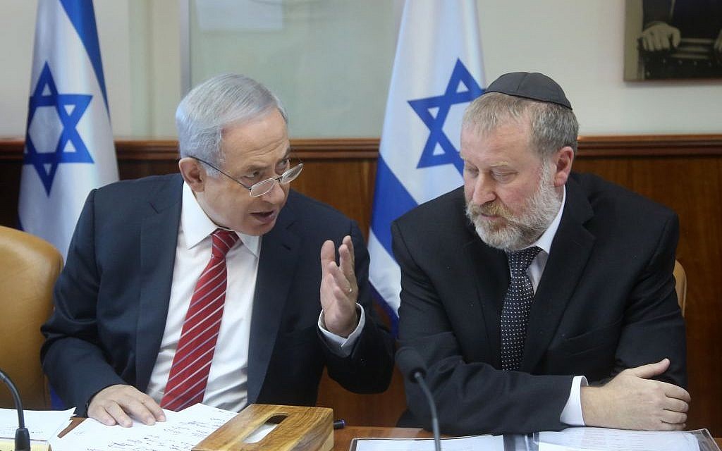 Prime Minister Benjamin Netanyahu speaks with then-cabinet secretary Avichai Mandelblit in Jerusalem on December 27, 2015. (Marc Israel Sellem/Pool)