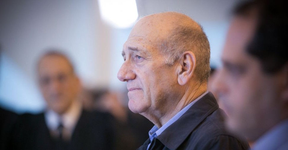 Former prime minister Ehud Olmert speaks to the press at the Jerusalem Supreme Court on December 29, 2015. The court reduced Olmert's sentence to 18 months, following a conviction on corruption charges in the Holyland affair. (Noam Moskowitz/POOL)