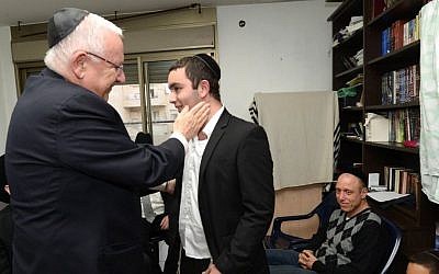 President Reuven Rivlin visits the family of Rabbi Reuven Birmacher, who was murdered in a terror attack in Jerusalem last week, on December 27, 2015. (Mark Neyman/GPO)